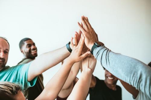 Cheerful people doing a group high five - 1225114