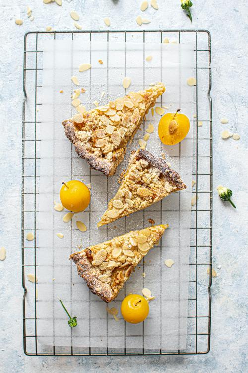 Sliced mirabelle plum tart on a cooling rack - 1225249