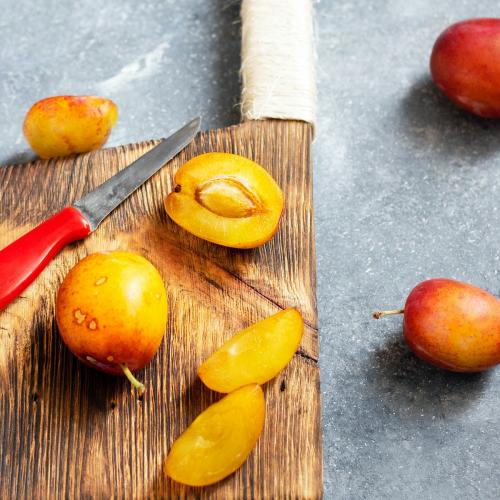 Fresh ripe plums on a cutting board - 1225261