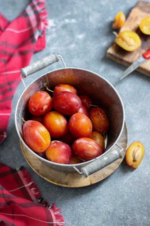 Fresh ripe plums in a pot - 1225289