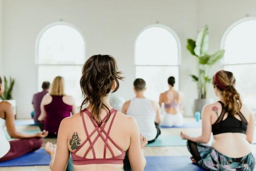 Healthy people doing a Sukhasana yoga pose in a yaga class - 1226867