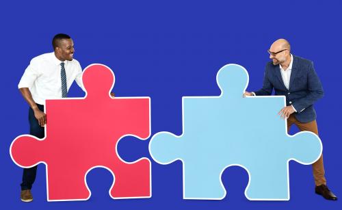 Two men connecting puzzle pieces - 470090