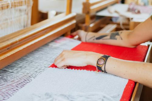 Woman weaving on a loom - 1232114