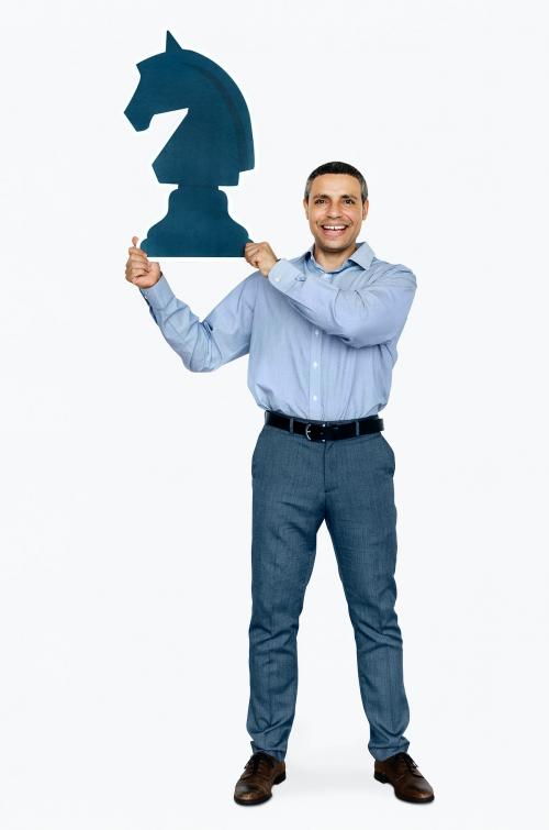 Businessman holding a chess piece - 468258