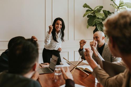 Businesswoman motivating her team members in a meeting - 1216754