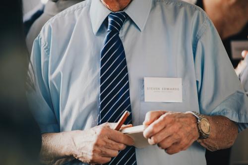 Businessman in a meeting holding a notebook and pen - 1217951