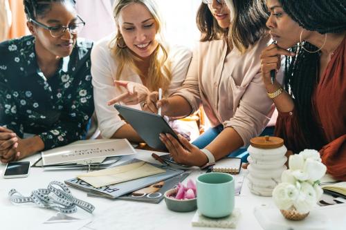 Fashion designers having a meeting using a digital tablet - 1220872