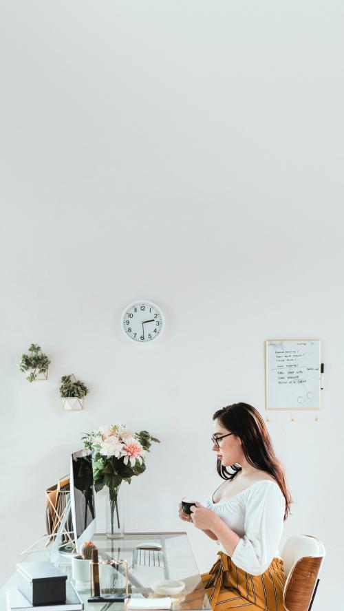 Businesswoman with a cup of coffee in the office - 1225078