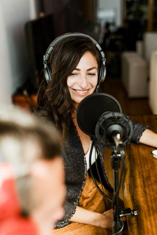 Female radio host broadcasting live in a studio - 1225614