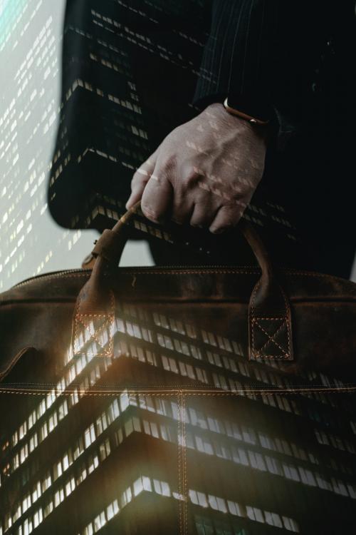 Businessman carrying his brown leather business bag - 1226698