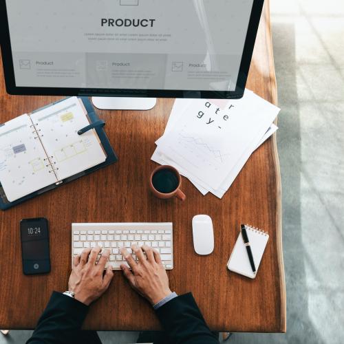 Busy businessman using a computer to plan a new product - 1226714