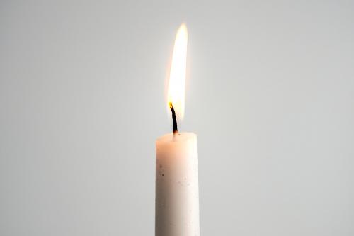 A white pillar candle burning for Christmas day - 1231419