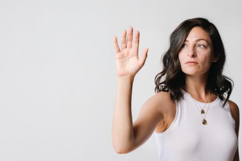 Woman touching a screen with her palm - 1233800