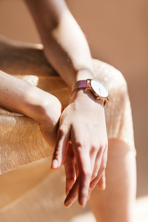 Woman wearing a pink gold wristwatch - 1235435