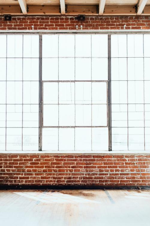 Brick wall with big glass window interior background - 1235540