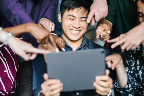 Group of diverse business people watching a content on a digital tablet together - 2012769