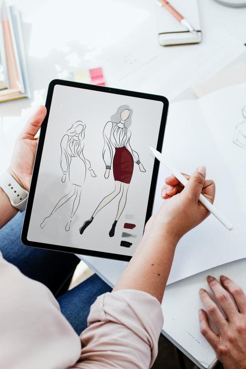 Fashion designer drawing on a digital tablet - 1220809