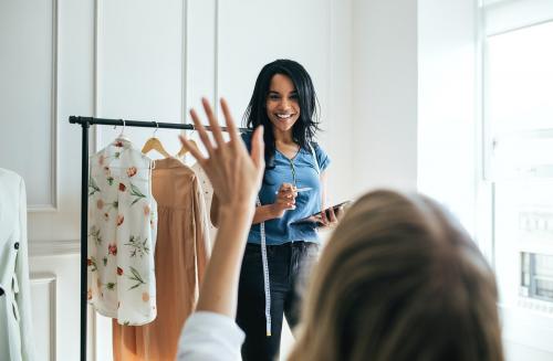 Young female designer in a boutique - 1220861