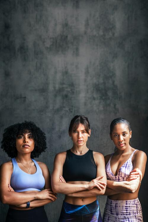 Sportive female personal coaches standing with arms crossed - 1222510