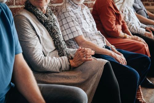 Group of elderly people sitting in a row - 1223747