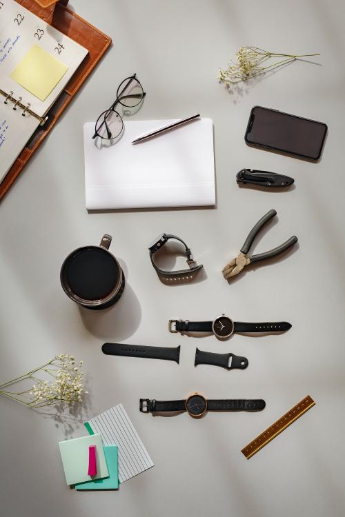 Watches and a plier on a table - 1226329