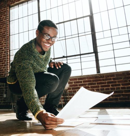 Businessman planning a marketing strategy on a wooden floor - 1226854