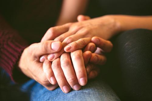 Sweet couple holding hands close up - 1227020