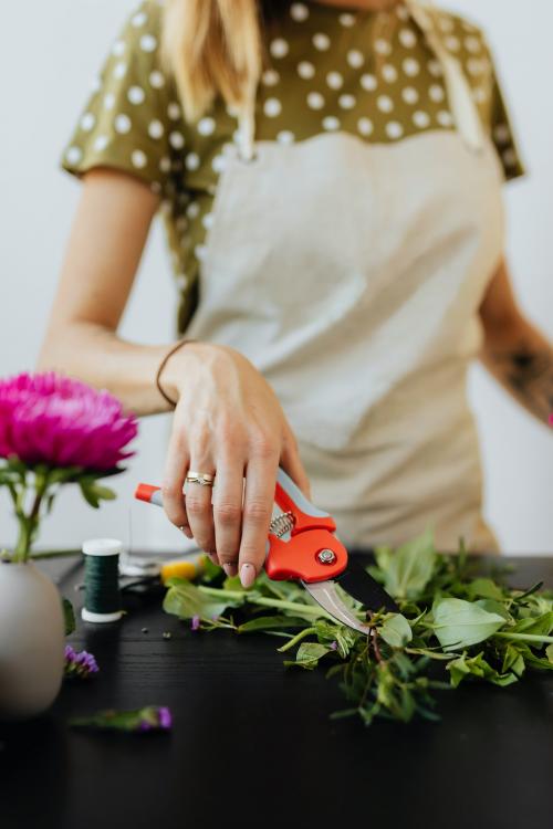 Blond woman making a bouquet of flowers - 1232041