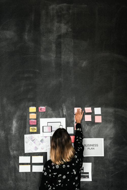 Leader in a startup company brainstorming using a blackboard - 2012909