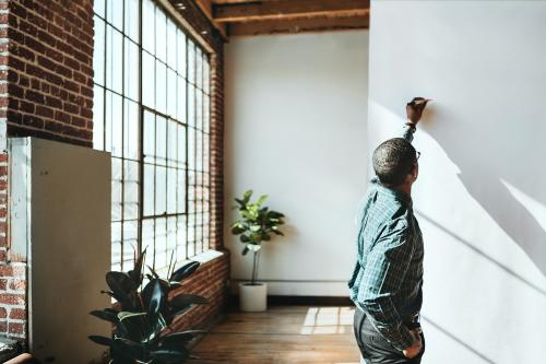 Businessman writing on a white poster - 2019880