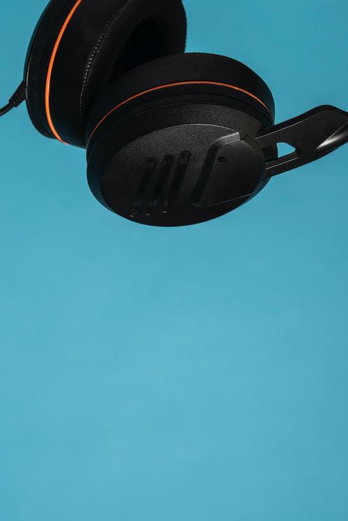 Black headphones isolated on blue background - 598241