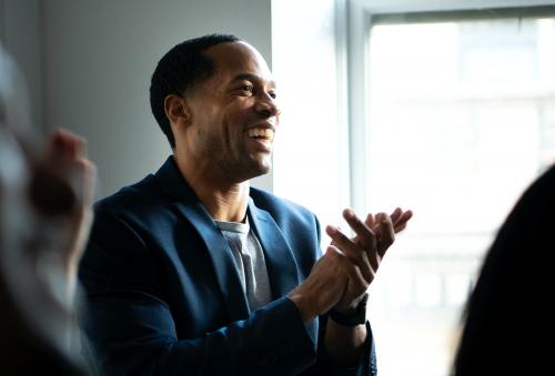 African American man clapping in a seminar - 1216797