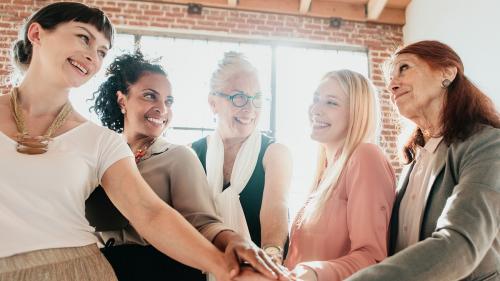 Women joining hands in the middle - 1217959