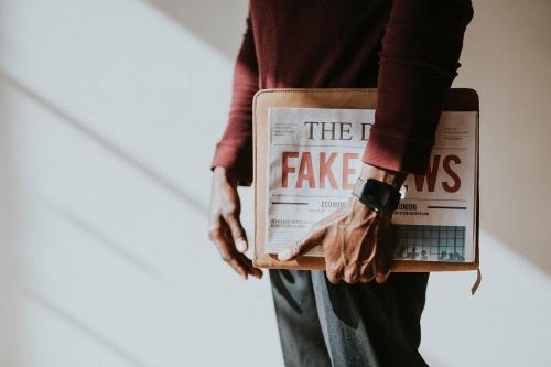 Man holding a newspaper - 1219016