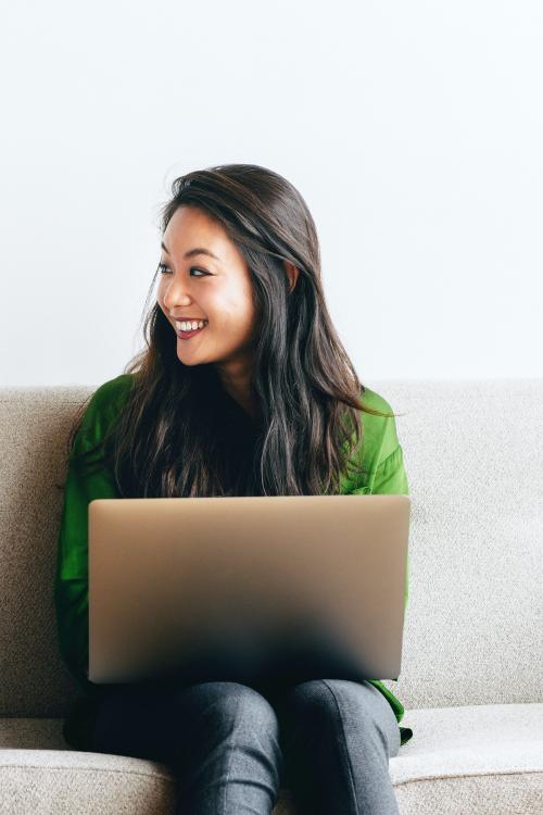 Cheerful woman using a laptop at home - 1226481