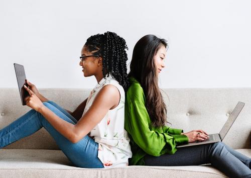 Diverse women sitting together using digital devices - 1226506