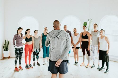 Trainer and his students in a gym - 1226910