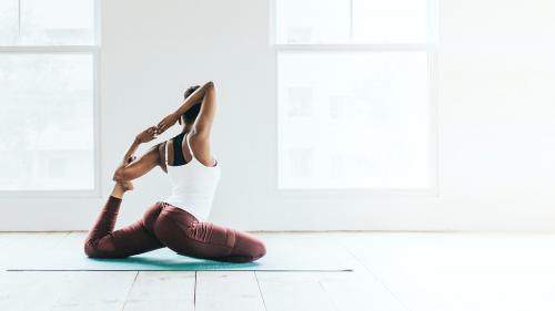 Black woman doing a Naginyasana pose - 1226971