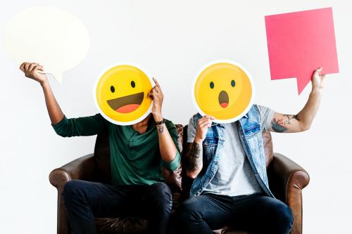 Cheerful people holding emoticon icon - 414607