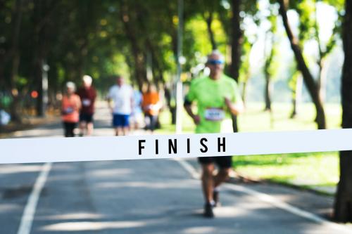 Mature man running towards the finish line - 416683