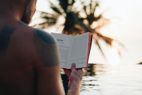 Man reading a book in the swimming pool - 418531