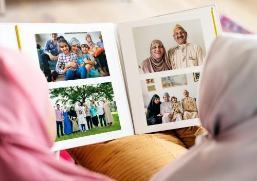 Muslim family looking in a photo album - 425689