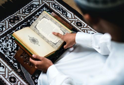 Muslim man studying The Quran - 425803