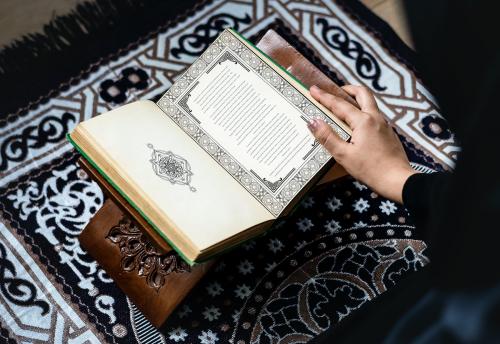 Muslim woman reading from the quran - 425820