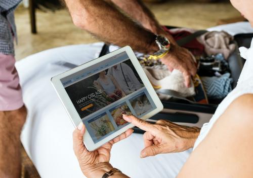 Senior woman using a tablet on the bed - 428737