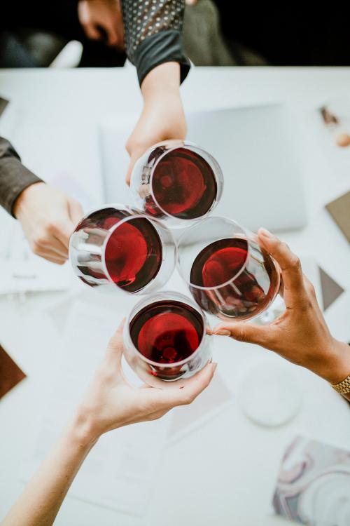 Colleagues toasting wine glasses at work - 1220757