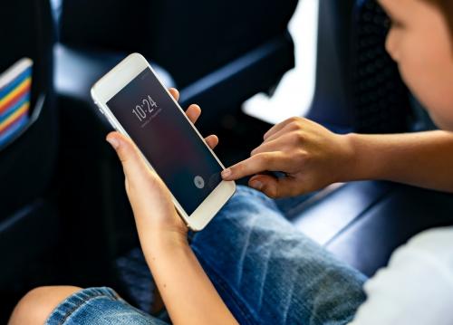 Boy playing on a smartphone in the car - 431031