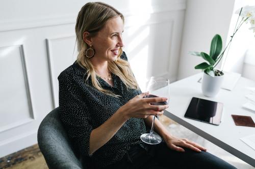 Woman having a glass of red wine - 1220885