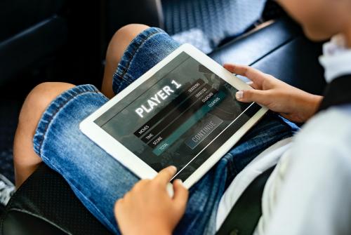 Boy playing on a digital tablet in the car - 431207