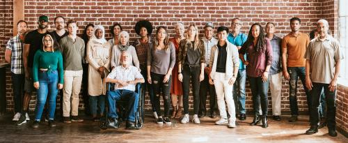 Group of diverse people standing in front of a brick wall - 1223855